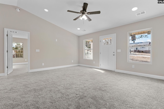 unfurnished living room with lofted ceiling, healthy amount of natural light, carpet floors, ceiling fan, and recessed lighting
