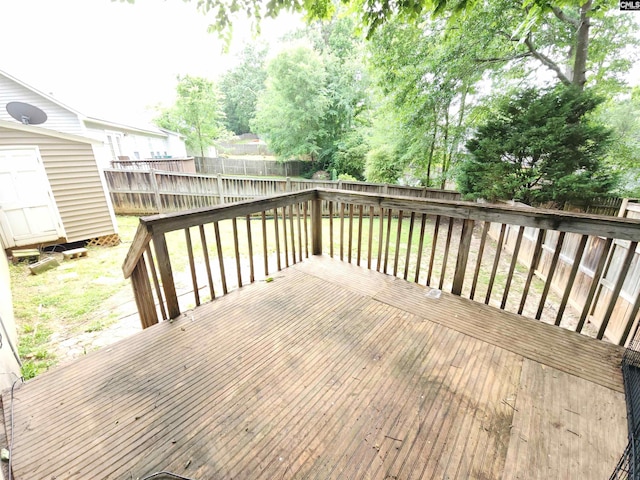 wooden deck with a shed and an outdoor structure
