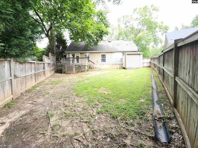 view of yard with a deck and an outdoor structure
