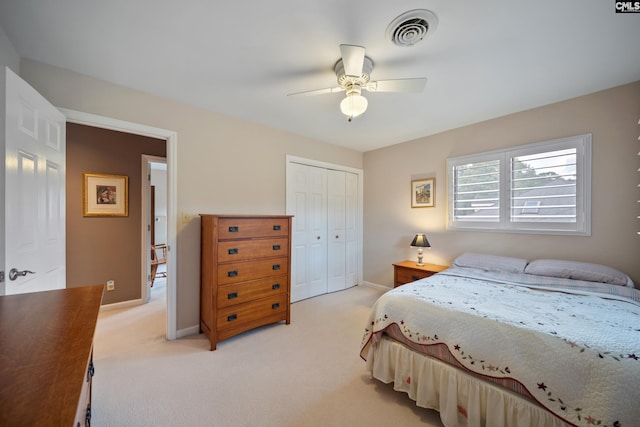 bedroom with a closet, light carpet, baseboards, and ceiling fan