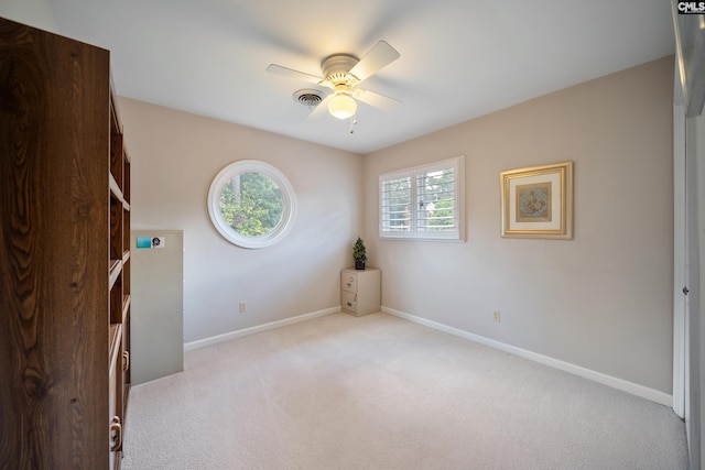 empty room with a ceiling fan, carpet, and baseboards