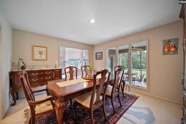 dining room with light colored carpet, baseboards, plenty of natural light, and recessed lighting