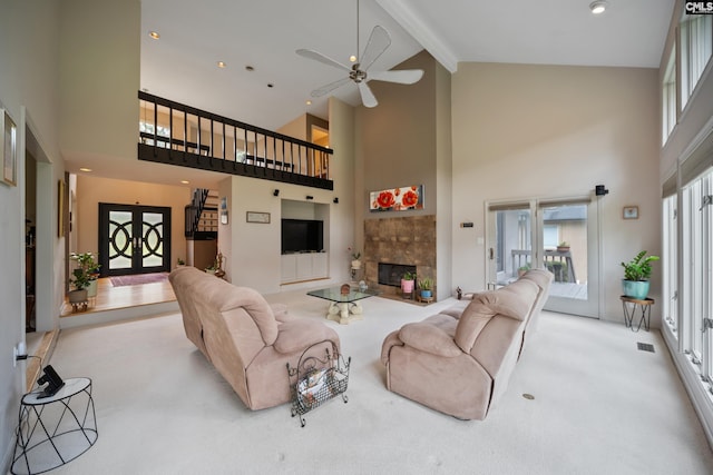 carpeted living area featuring high vaulted ceiling, beamed ceiling, a ceiling fan, a tiled fireplace, and recessed lighting