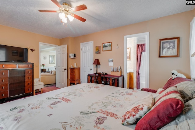 bedroom with a textured ceiling, connected bathroom, and a ceiling fan