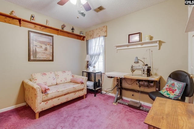 sitting room with carpet flooring, ceiling fan, baseboards, and a textured ceiling