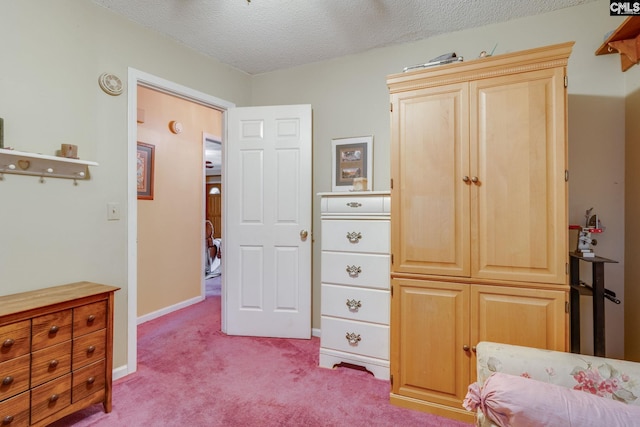 living area featuring light carpet, a textured ceiling, and baseboards