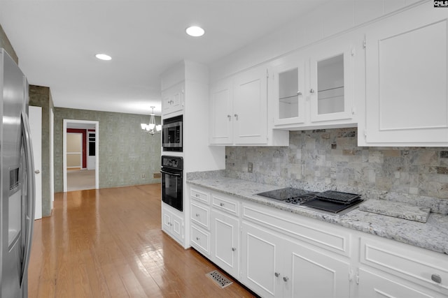 731 Trafalgar Dr, Columbia, SC 29210 - kitchen featuring black appliances, white cabinetry, a chandelier, and recessed lighting