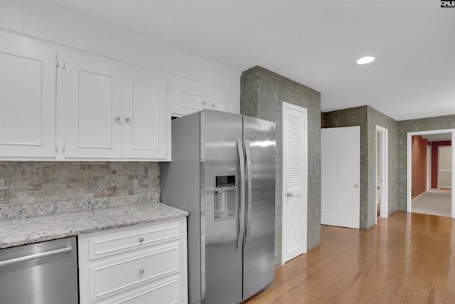 731 Trafalgar Dr, Columbia, SC 29210 - kitchen featuring stainless steel appliances, white cabinetry, light wood-style floors, decorative backsplash, and light stone countertops