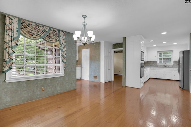 731 Trafalgar Dr, Columbia, SC 29210 - unfurnished dining area featuring light wood-style flooring, a chandelier, a sink, and recessed lighting