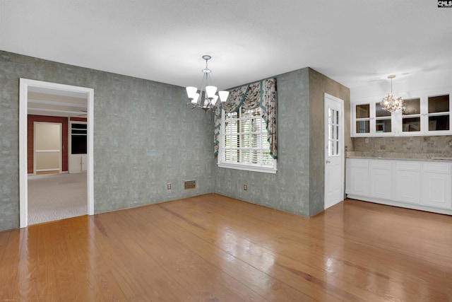 731 Trafalgar Dr, Columbia, SC 29210 - unfurnished dining area featuring a chandelier, light wood-style floors, and wallpapered walls