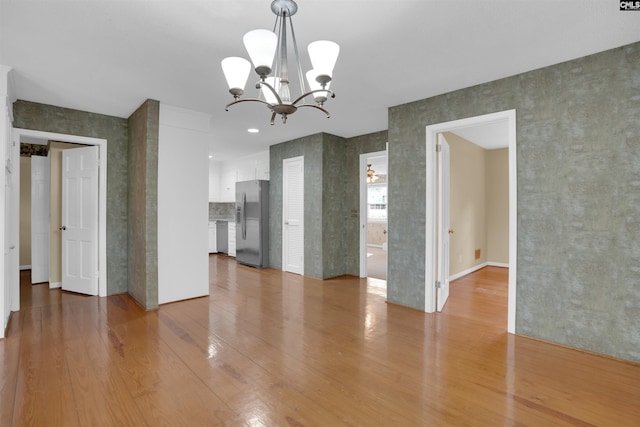 731 Trafalgar Dr, Columbia, SC 29210 - unfurnished living room with light wood-type flooring and a chandelier