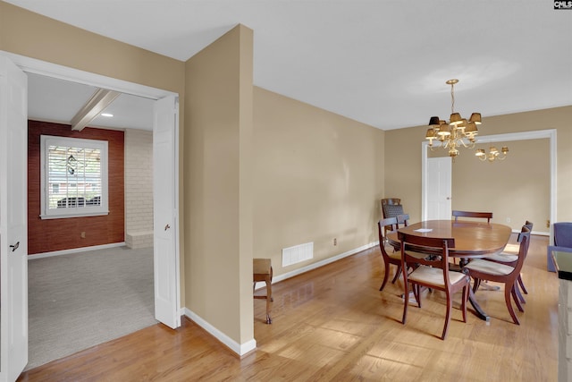 731 Trafalgar Dr, Columbia, SC 29210 - dining space featuring a chandelier, baseboards, light wood-style flooring, and beamed ceiling