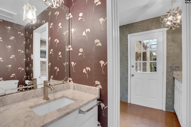 731 Trafalgar Dr, Columbia, SC 29210 - bathroom with wood finished floors, wallpapered walls, vanity, and toilet