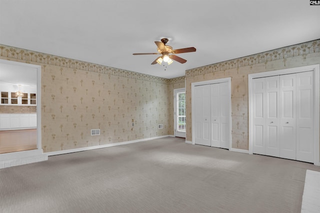 731 Trafalgar Dr, Columbia, SC 29210 - unfurnished bedroom featuring carpet floors, wallpapered walls, multiple closets, baseboards, and a ceiling fan