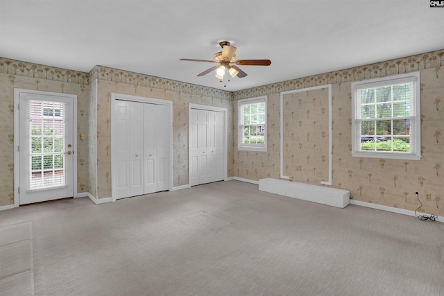 731 Trafalgar Dr, Columbia, SC 29210 - unfurnished bedroom featuring carpet floors, baseboards, wallpapered walls, multiple closets, and access to exterior
