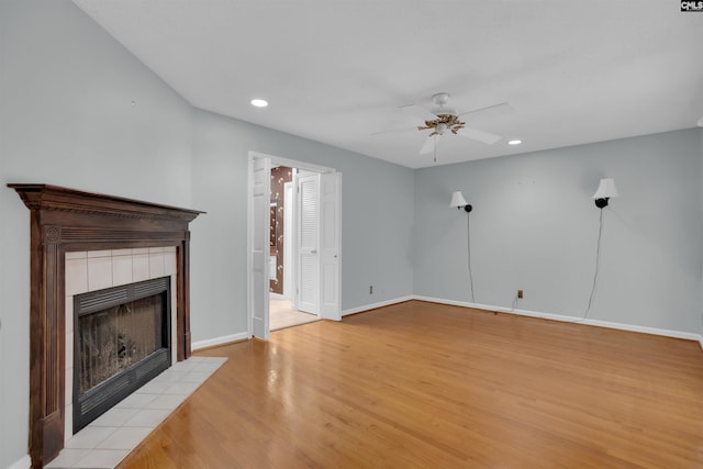 731 Trafalgar Dr, Columbia, SC 29210 - unfurnished living room with a tiled fireplace, ceiling fan, light wood finished floors, recessed lighting, and baseboards