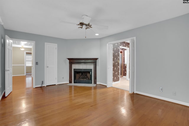 731 Trafalgar Dr, Columbia, SC 29210 - unfurnished living room featuring a tiled fireplace, ceiling fan, wood finished floors, and baseboards