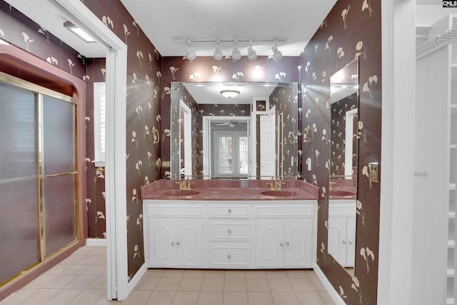 731 Trafalgar Dr, Columbia, SC 29210 - full bathroom featuring wallpapered walls, rail lighting, tile patterned flooring, double vanity, and a stall shower