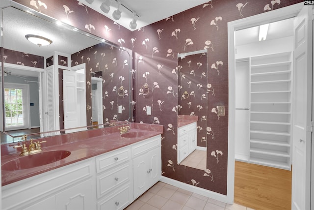 731 Trafalgar Dr, Columbia, SC 29210 - bathroom with wallpapered walls, double vanity, a walk in closet, and tile patterned flooring