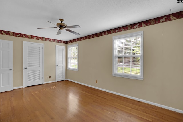 731 Trafalgar Dr, Columbia, SC 29210 - unfurnished bedroom featuring two closets, wood finished floors, baseboards, and ceiling fan