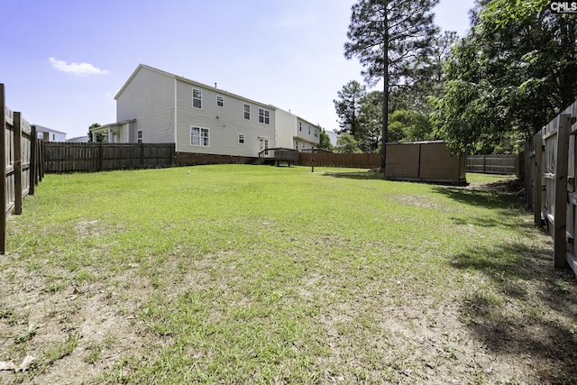 view of yard featuring a storage unit and an outbuilding