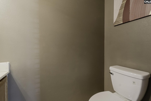 bathroom featuring toilet and vanity