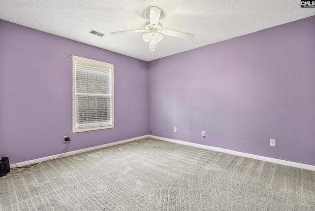unfurnished room featuring carpet, a ceiling fan, baseboards, and a textured ceiling
