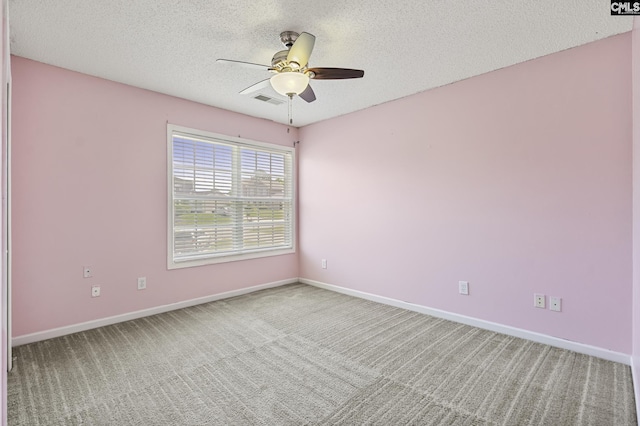 unfurnished room with light carpet, ceiling fan, a textured ceiling, and baseboards