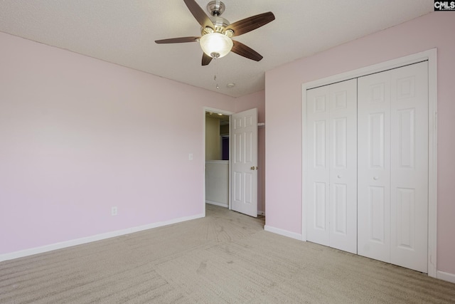 unfurnished bedroom with carpet, baseboards, and a closet