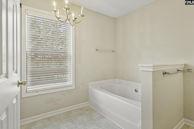 bathroom with a chandelier, a garden tub, and baseboards