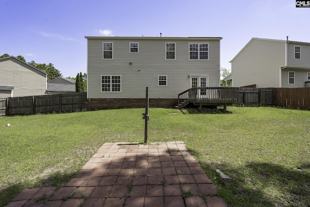 back of house featuring a deck and a patio area