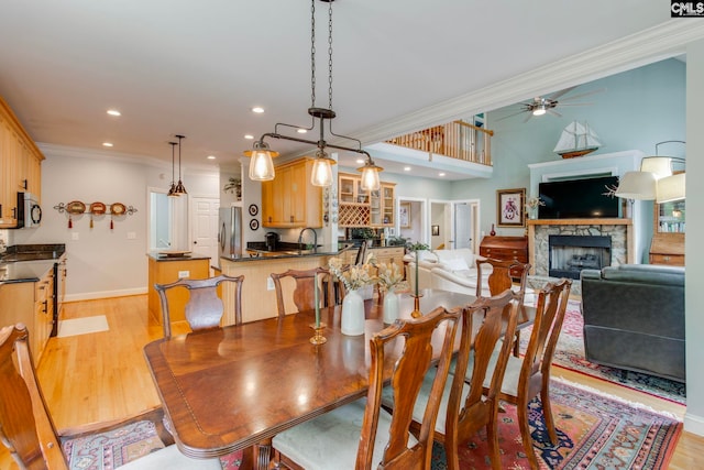 570 Wateree Key Ct, Winnsboro, SC 29180 - dining area featuring ornamental molding, a ceiling fan, a fireplace, light wood finished floors, and recessed lighting