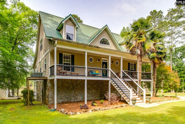 570 Wateree Key Ct, Winnsboro, SC 29180 - view of front of house featuring stone siding, a front lawn, stairs, covered porch, and a metal roof