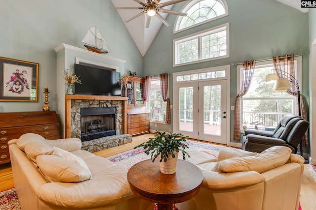 570 Wateree Key Ct, Winnsboro, SC 29180 - living area featuring high vaulted ceiling, wood finished floors, a ceiling fan, plenty of natural light, and a stone fireplace
