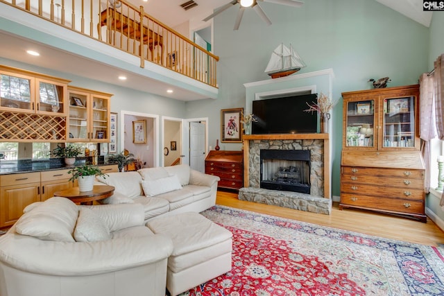 570 Wateree Key Ct, Winnsboro, SC 29180 - living area with high vaulted ceiling, ceiling fan, light wood-style flooring, a stone fireplace, and recessed lighting
