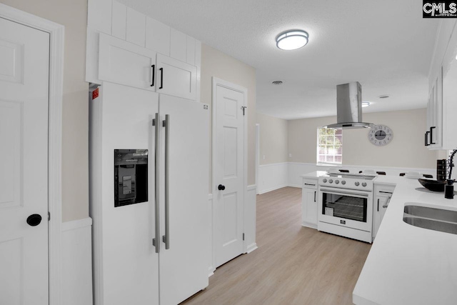 3102 Travis Ct, Columbia, SC 29204 - kitchen featuring white fridge with ice dispenser, range with electric stovetop, island exhaust hood, light wood finished floors, and white cabinets