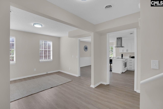 3102 Travis Ct, Columbia, SC 29204 - unfurnished room featuring wood finished floors, healthy amount of natural light, baseboards, and a textured ceiling