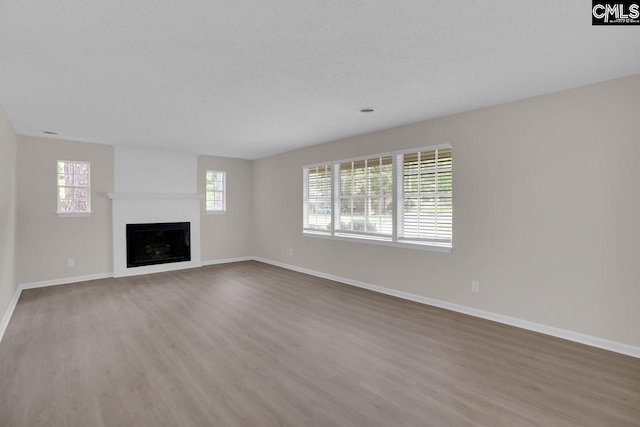 3102 Travis Ct, Columbia, SC 29204 - unfurnished living room with baseboards, wood finished floors, a fireplace, and a textured ceiling