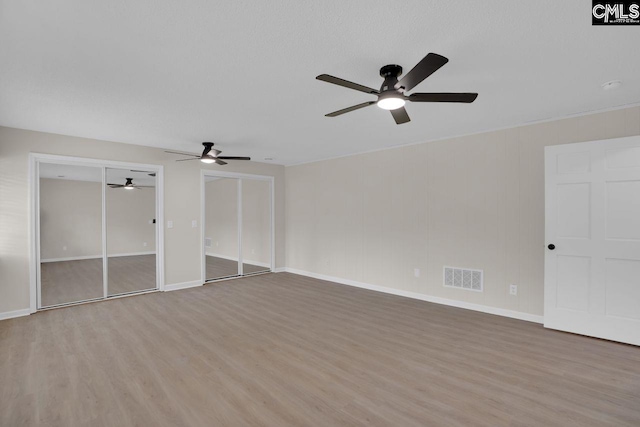3102 Travis Ct, Columbia, SC 29204 - unfurnished bedroom featuring light wood-style flooring, two closets, and baseboards