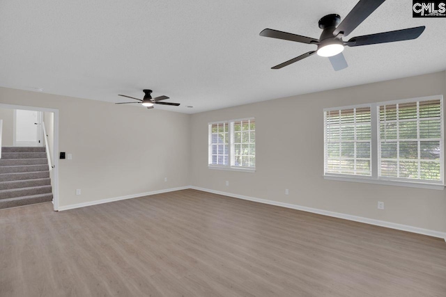 3102 Travis Ct, Columbia, SC 29204 - unfurnished room featuring a ceiling fan, light wood-style floors, baseboards, and stairway