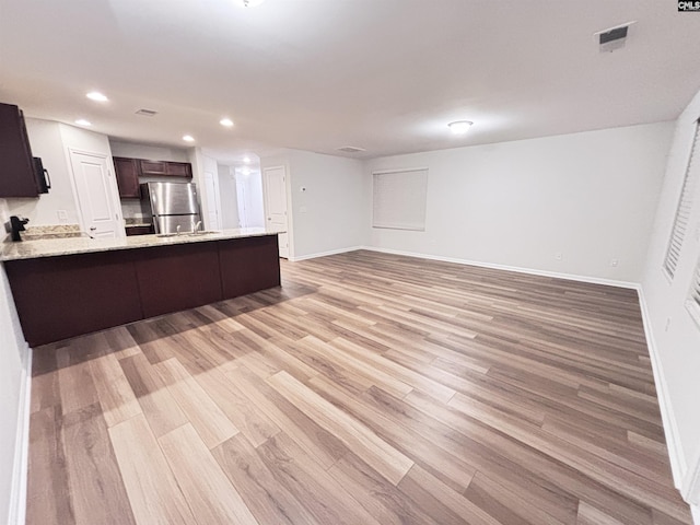 407 Eclipse Ln, Elgin, SC 29045 - kitchen featuring freestanding refrigerator, a peninsula, light wood-type flooring, open floor plan, and recessed lighting