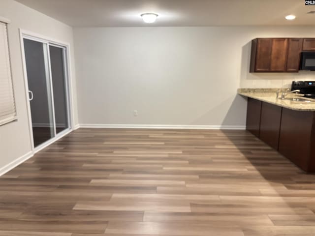 407 Eclipse Ln, Elgin, SC 29045 - kitchen with black appliances, baseboards, wood finished floors, a sink, and dark brown cabinetry
