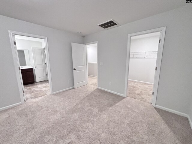 407 Eclipse Ln, Elgin, SC 29045 - unfurnished bedroom featuring light colored carpet, a spacious closet, and baseboards