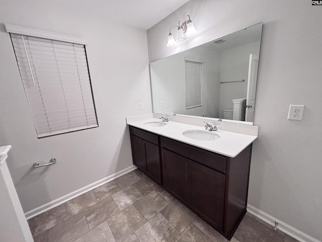 407 Eclipse Ln, Elgin, SC 29045 - full bathroom featuring baseboards, toilet, double vanity, and stone finish flooring