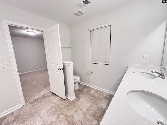 407 Eclipse Ln, Elgin, SC 29045 - bathroom with toilet, baseboards, double vanity, and stone finish flooring