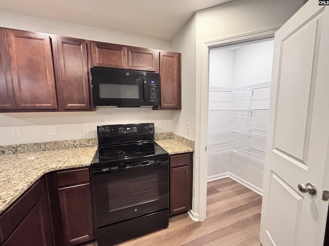 407 Eclipse Ln, Elgin, SC 29045 - kitchen featuring black appliances, light wood finished floors, and light stone counters