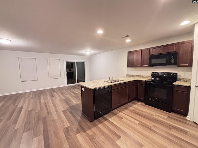 407 Eclipse Ln, Elgin, SC 29045 - kitchen with black appliances, light wood finished floors, a sink, dark brown cabinets, and recessed lighting