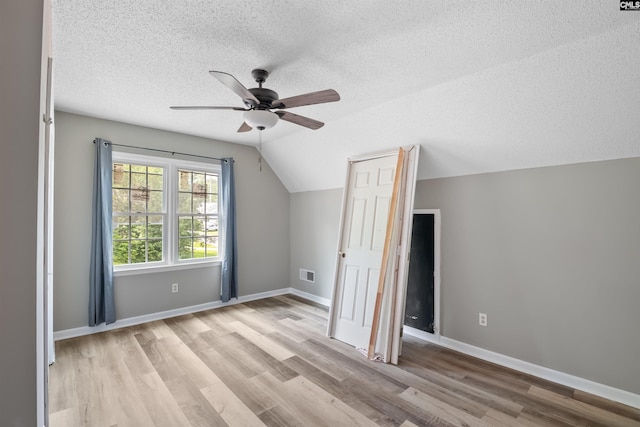 200 Kemsing Rd, Columbia, SC 29212 - additional living space featuring ceiling fan, light wood-type flooring, a textured ceiling, vaulted ceiling, and baseboards
