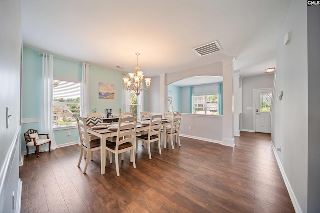 415 Mulberry Ridge Ct, Lexington, SC 29073 - dining room with ornate columns, dark wood-style floors, a chandelier, arched walkways, and plenty of natural light