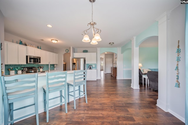 415 Mulberry Ridge Ct, Lexington, SC 29073 - kitchen featuring stainless steel appliances, arched walkways, tasteful backsplash, a chandelier, and a peninsula